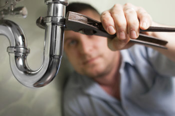 Plumber Fixing Sink Pipes